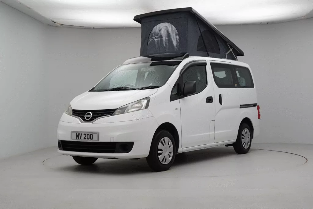 White Nissan camper van with pop-up roof